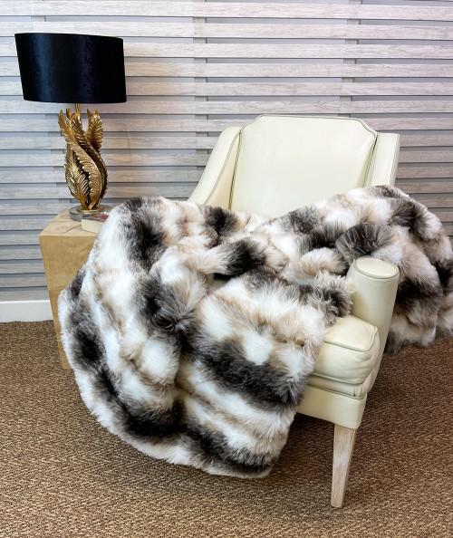 White and brown striped fake fur blanket or bedspread