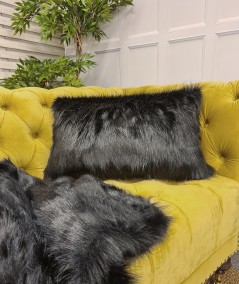 Black rectangular sofa cushion with matching throw in luxurious faux fur