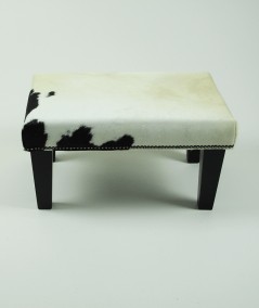 Small cream cowhide footstool with a small black patch 325