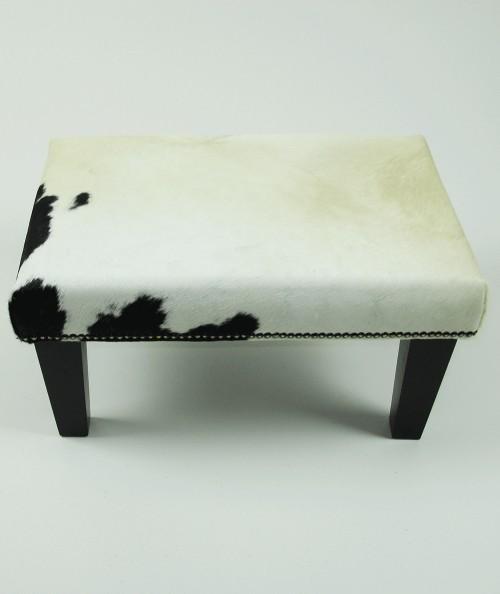 Small cream hair on hide footstool with a small black patch 325